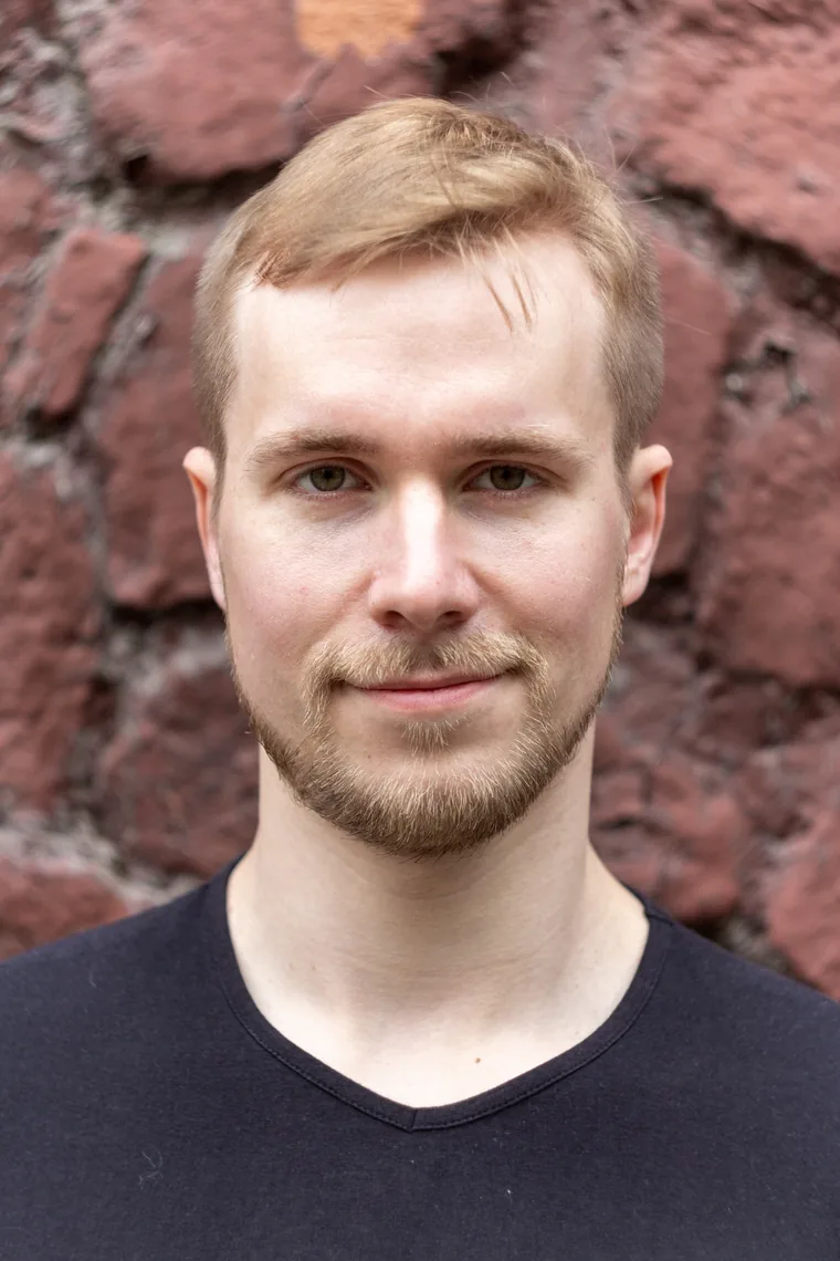 Stepan Diadorov — portrait in front of a red brick wall